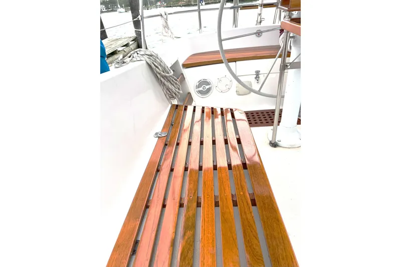 Slide: The Image of Wooden deck of 1989 Tartan 37 sailboat with steering wheel and ropes. - 29