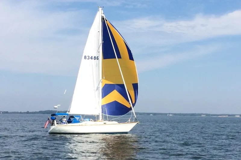 Slide: The Image of Sailboat Tartan 37 (1989) with colorful spinnaker on open water. - 3
