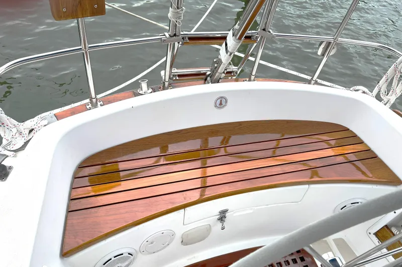Slide: The Image of Cockpit of 1989 Tartan 37 sailboat with polished wooden seating and stainless steel railings. - 30