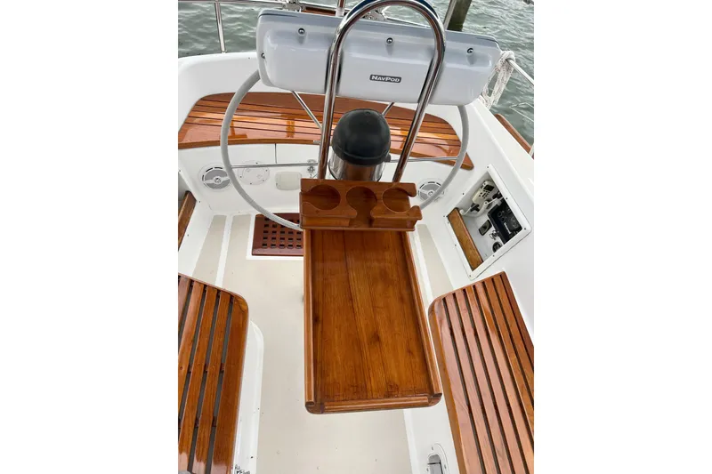 Slide: The Image of Cockpit of 1989 Tartan 37 sailboat with wooden seating and steering wheel. - 31