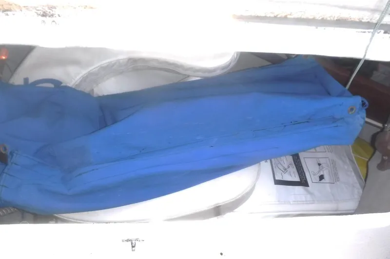 Slide: The Image of Storage compartment on a 1989 Tartan 37 sailboat with blue canvas and life preserver. - 32