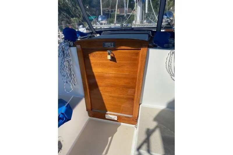 Slide: The Image of 1989 Tartan 37 sailboat cockpit with wooden hatch and nautical ropes. - 33