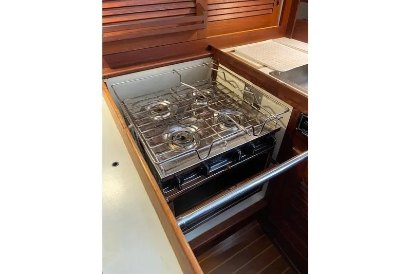 Slide: The Image of 1989 Tartan 37 yacht kitchen with stove and wooden cabinetry. - 38