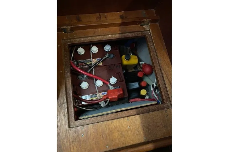 Slide: The Image of Battery compartment of a 1989 Tartan 37 sailboat with visible wiring and connectors. - 42