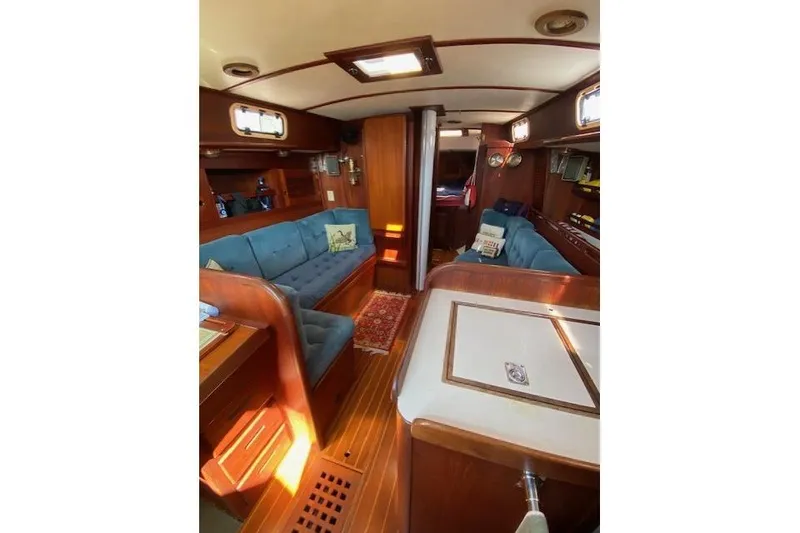 Slide: The Image of Interior of 1989 Tartan 37 sailboat with wooden furnishings and blue seating. - 43