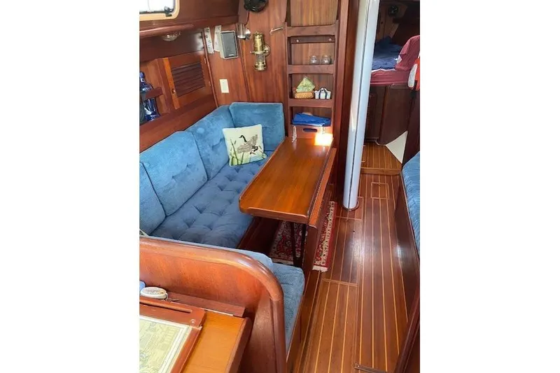 Slide: The Image of Cozy interior of 1989 Tartan 37 sailboat with blue seating and wooden finishes. - 49