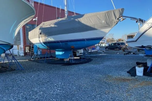 Slide: The Image of Sailboat Tartan 37, 1989 model, covered and docked in a boatyard. - 5