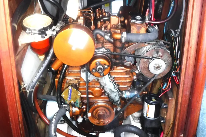Slide: The Image of Engine compartment of a 1989 Tartan 37 sailboat, showcasing detailed mechanical components. - 55