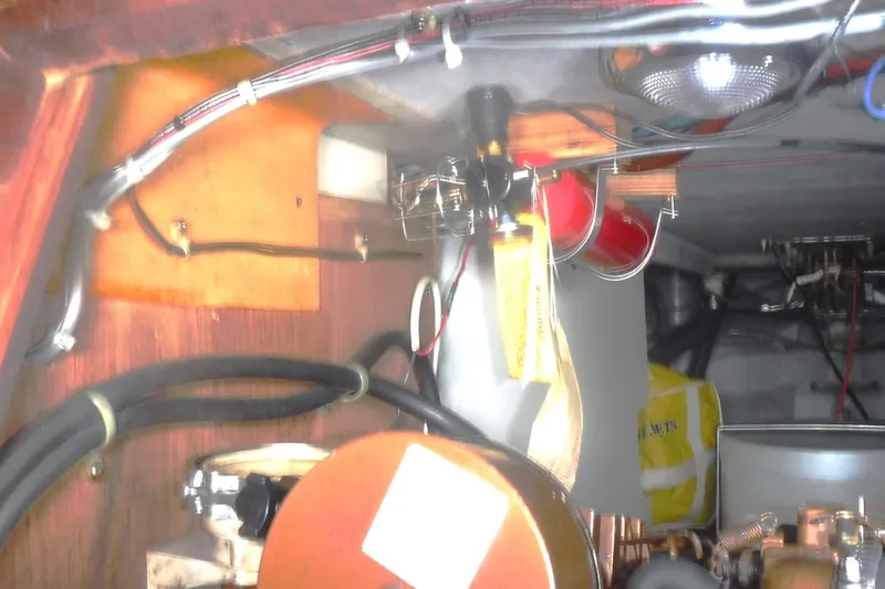 Slide: The Image of Engine compartment of a 1989 Tartan 37 sailboat with wiring and mechanical components. - 56