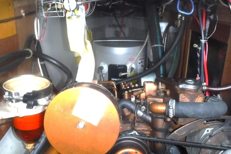 Slide: The Image of Engine compartment of a 1989 Tartan 37 sailboat with visible components and wiring. - 57