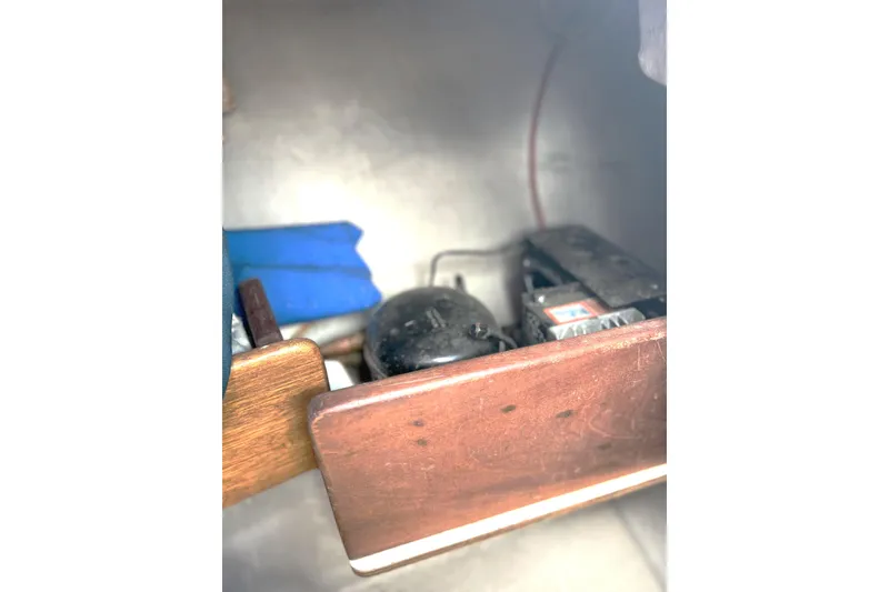 Slide: The Image of Interior view of a 1989 Tartan 37 sailboat engine compartment with visible components. - 61