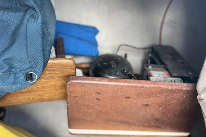 Slide: The Image of Interior of a 1989 Tartan 37 sailboat showing storage area with equipment and fabric items. - 62