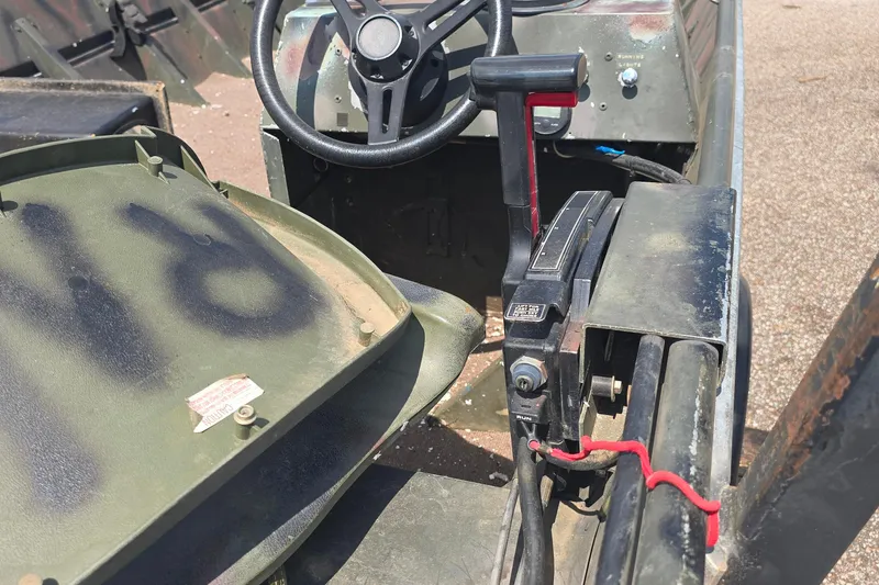 Slide: The Image of 1989 Polar Kraft 17 boat interior with steering wheel and control lever. - 3