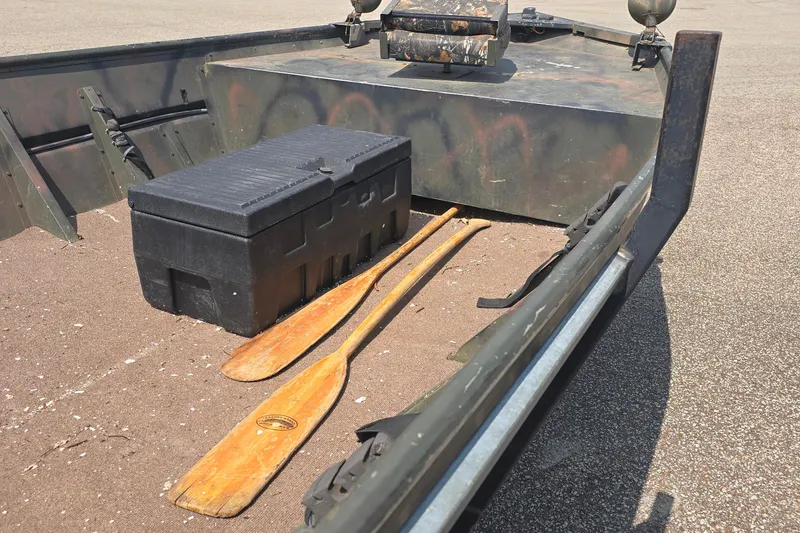 Slide: The Image of 1989 Polar Kraft 17 boat interior with paddles and storage box. - 5