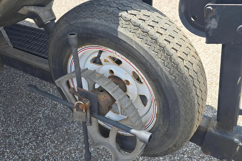 Slide: The Image of Trailer wheel with a tire lock and lug wrench, Polar Kraft 17, 1989 model. - 7