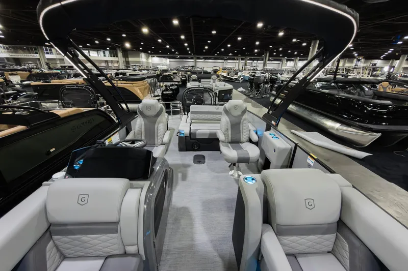 Slide: The Image of Luxurious 2026 Godfrey Monaco 25' Tritoon with elegant seating at a boat show. - 10