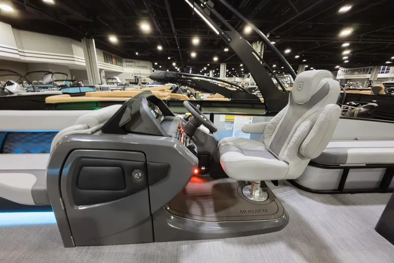 Slide: The Image of Luxurious helm of 2026 Godfrey Monaco 25' Tritoon with plush captain's chair. - 11