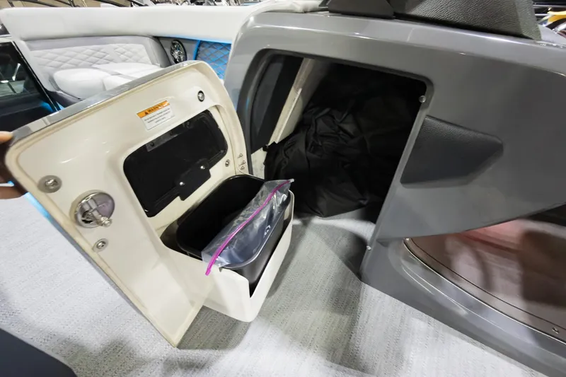 Slide: The Image of Storage compartment on 2026 Godfrey Monaco 25' Tritoon, featuring a built-in waste bin. - 12