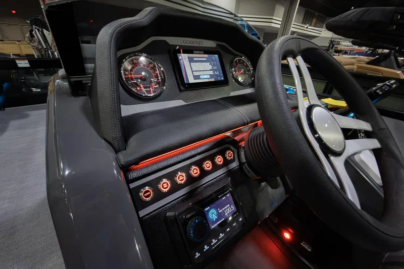 Slide: The Image of 2026 Godfrey Monaco 25' Tritoon dashboard with modern controls and illuminated gauges. - 13