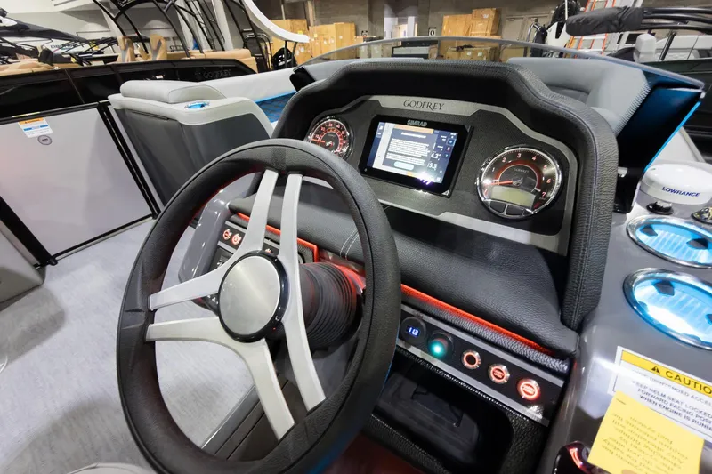 Slide: The Image of Interior dashboard of 2026 Godfrey Monaco 25' Tritoon with steering wheel and digital display. - 15