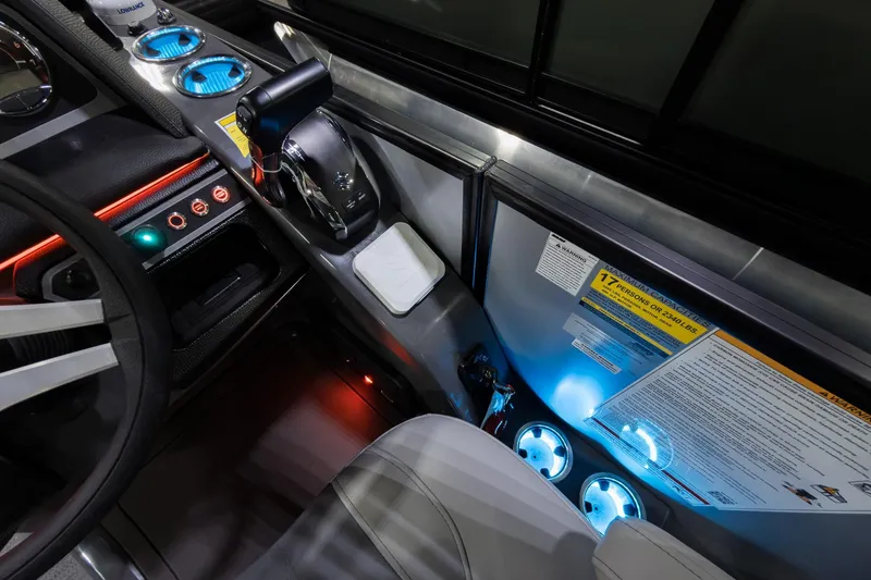 Slide: The Image of Interior of 2026 Godfrey Monaco 25' Tritoon with illuminated controls and cup holders. - 16