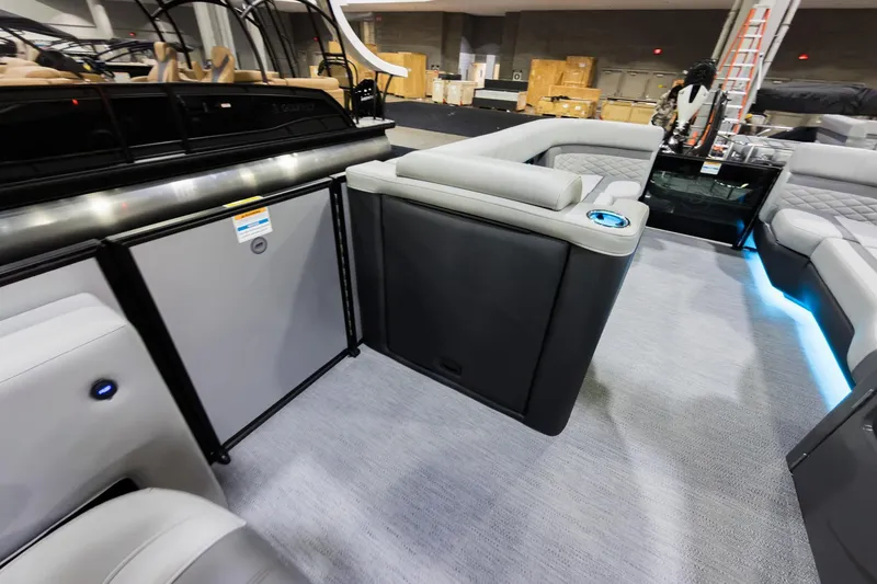 Slide: The Image of 2026 Godfrey Monaco 25' Tritoon interior with luxurious seating and ambient lighting. - 19