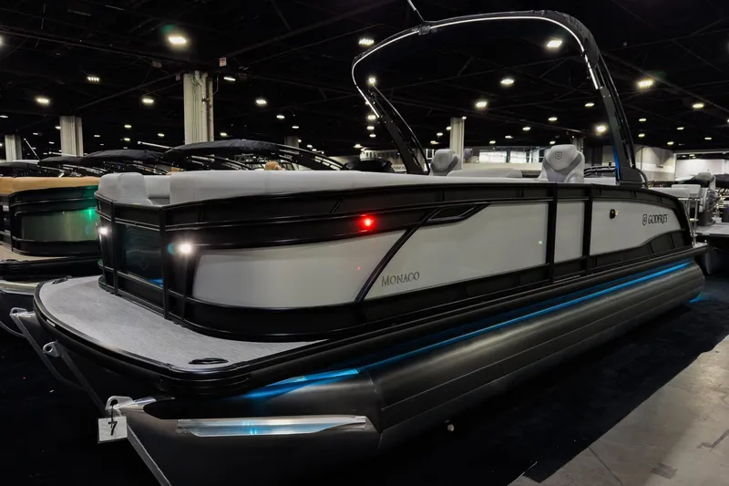 The Image of 2026 Godfrey Monaco 25' Tritoon boat with sleek design and modern features displayed indoors. - 2