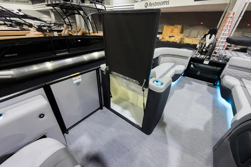 Slide: The Image of 2026 Godfrey Monaco 25' Tritoon interior with flip lounge, modern seating, and ambient lighting. - 20