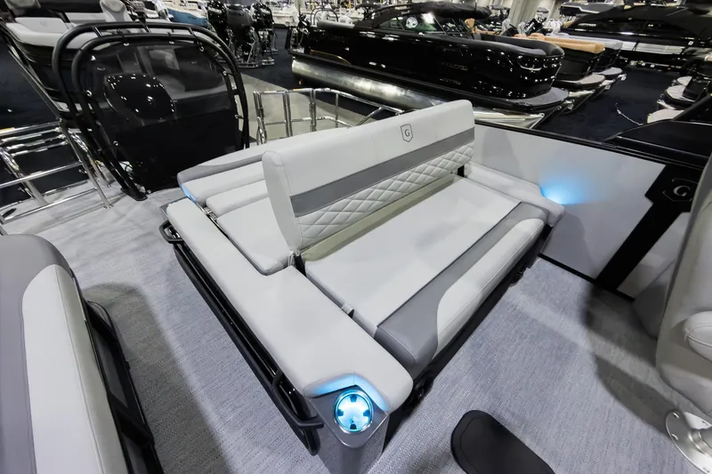 Slide: The Image of 2026 Godfrey Monaco 25' Tritoon with luxurious flip lounge seating and modern design. - 21