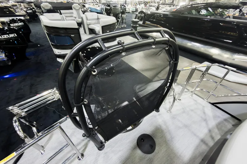 Slide: The Image of 2026 Godfrey Monaco 25' Tritoon with flip lounge, showcased at a boat exhibition. - 29