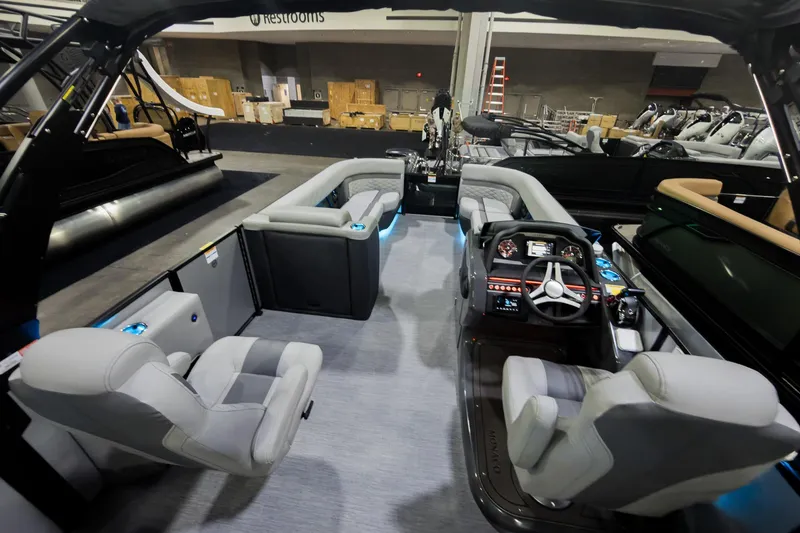 Slide: The Image of 2026 Godfrey Monaco 25' Tritoon interior with luxurious seating and modern helm controls. - 31