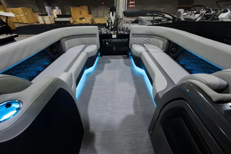 Slide: The Image of Luxurious interior of 2026 Godfrey Monaco 25' Tritoon with ambient blue lighting and plush seating. - 32