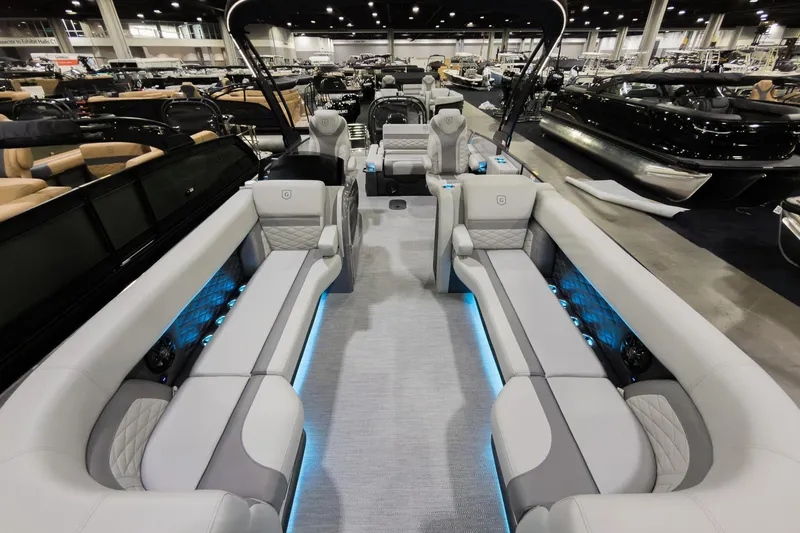 Slide: The Image of 2026 Godfrey Monaco 25' Tritoon interior with luxurious seating and ambient lighting. - 6