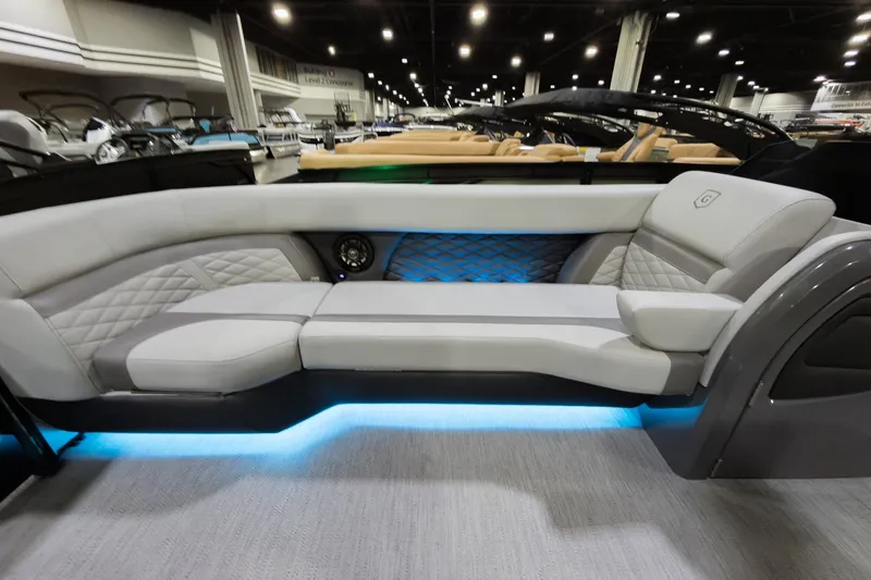 Slide: The Image of Luxurious interior of 2026 Godfrey Monaco 25' Tritoon with elegant seating and ambient lighting. - 7