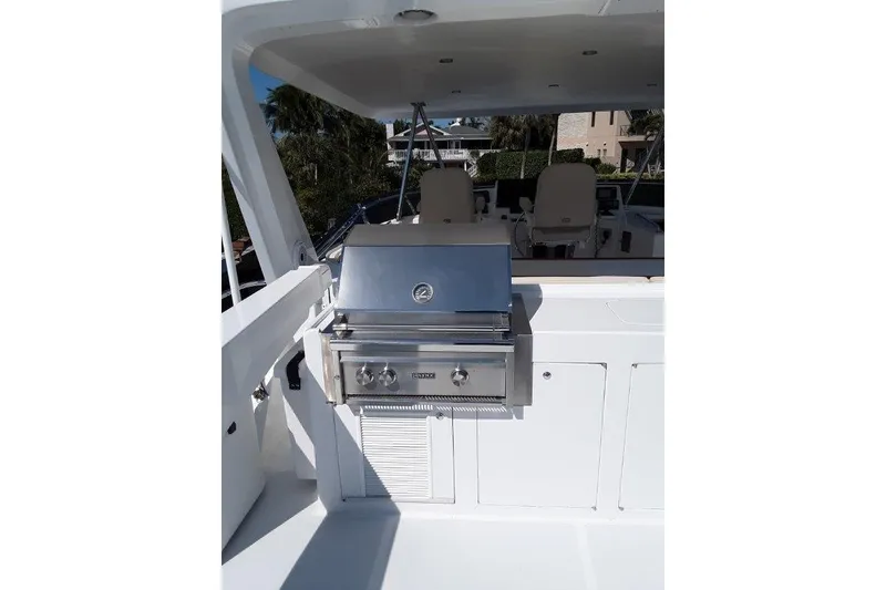 Slide: The Image of Outdoor grill on the Flybridge of 2008 Offshore Yachts 62 Flushdeck, featuring sleek stainless steel design. - 11