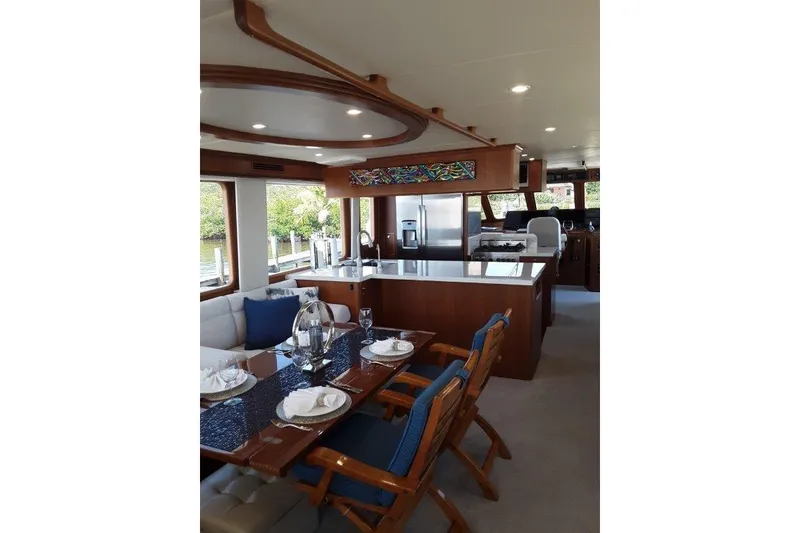 Slide: The Image of Luxurious interior of 2008 Offshore Yachts 62 Flushdeck, featuring elegant dining and kitchen area. - 17