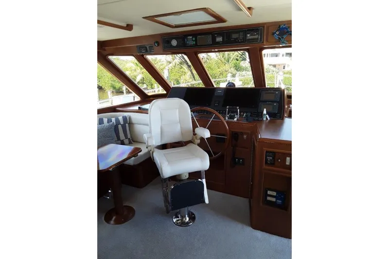 Slide: The Image of Interior helm of 2008 Offshore Yachts 62 Flushdeck, featuring captain's chair and navigation controls. - 25