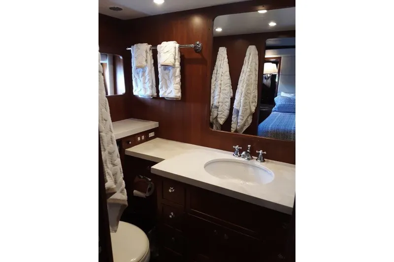 Slide: The Image of Master bathroom, featuring elegant wood cabinetry and modern fixtures. - 34
