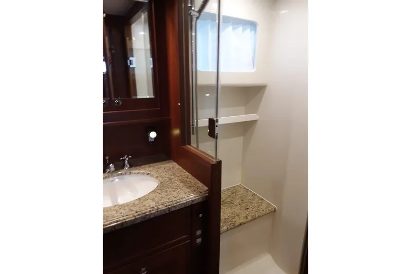 Slide: The Image of Luxurious bathroom in 2008 Offshore Yachts 62 Flushdeck with granite countertop and glass shower. - 37