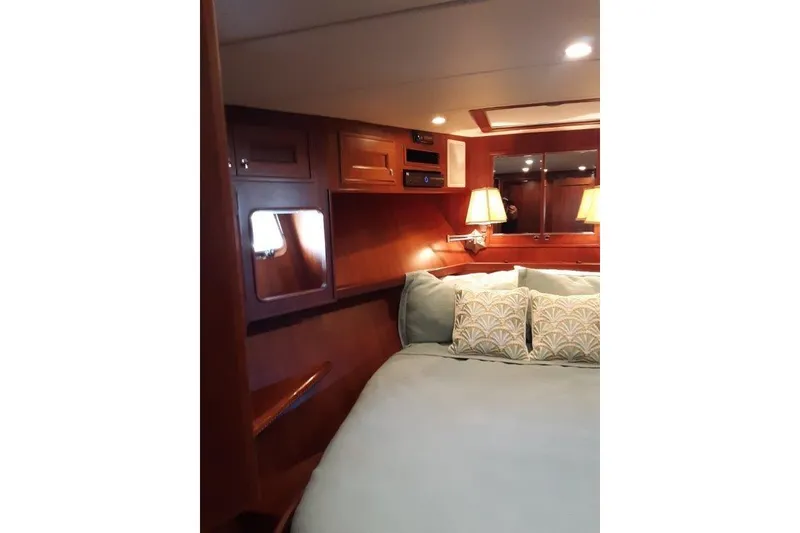 Slide: The Image of VIP Forward stateroom with queen bed. - 42