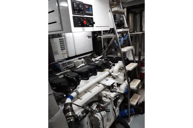 Slide: The Image of Engine room of 2008 Offshore Yachts 62 Flushdeck with Onan generator and control panels. - 48