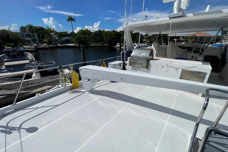 Slide: The Image of 2008 Offshore Yachts 62 Flushdeck, spacious deck with grill, docked by waterfront homes. - 55