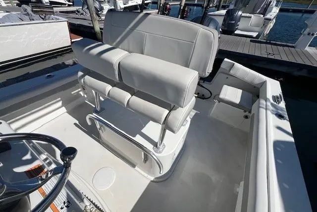 Slide: The Image of Parker 2100 Special Edition 2022 boat interior with cushioned seating and steering wheel. - 12
