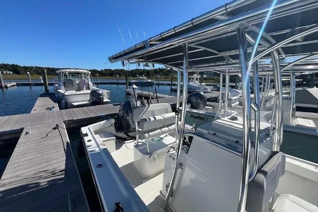 Slide: The Image of 2022 Parker 2100 Special Edition boat docked at marina under clear blue sky. - 15