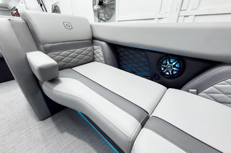 Slide: The Image of Luxurious seating in 2026 Godfrey Monaco 25' Tritoon with stylish design and integrated speaker. - 13