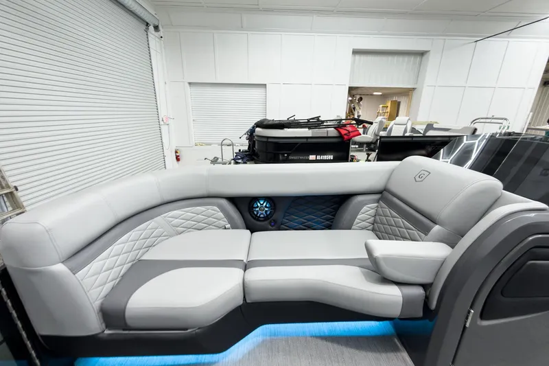 Slide: The Image of Luxurious interior of 2026 Godfrey Monaco 25' Tritoon with elegant seating and ambient lighting. - 16