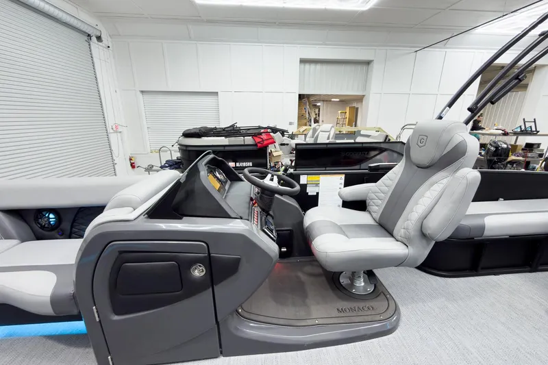 Slide: The Image of Interior view of 2026 Godfrey Monaco 25' Tritoon with luxurious seating and modern helm. - 20