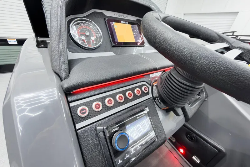 Slide: The Image of Dashboard of 2026 Godfrey Monaco 25' Tritoon with steering wheel and control panel. - 23