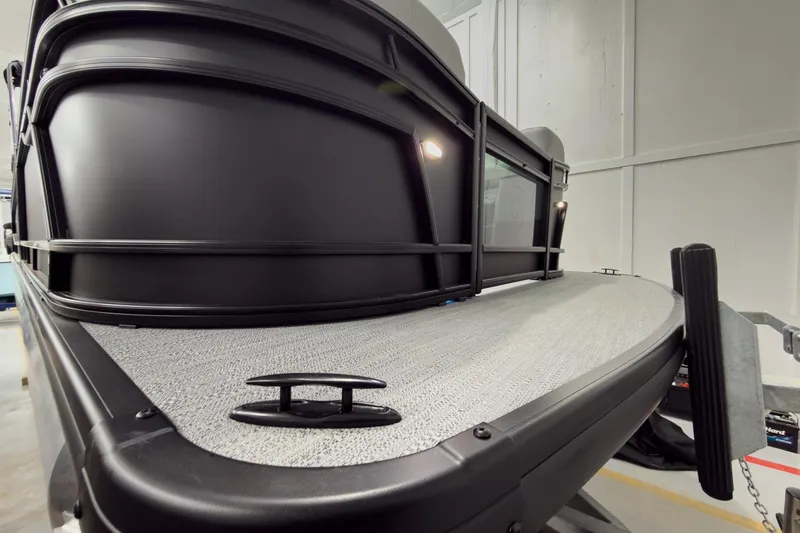 Slide: The Image of 2026 Godfrey Monaco 25' Tritoon boat, front view in a showroom setting. - 3