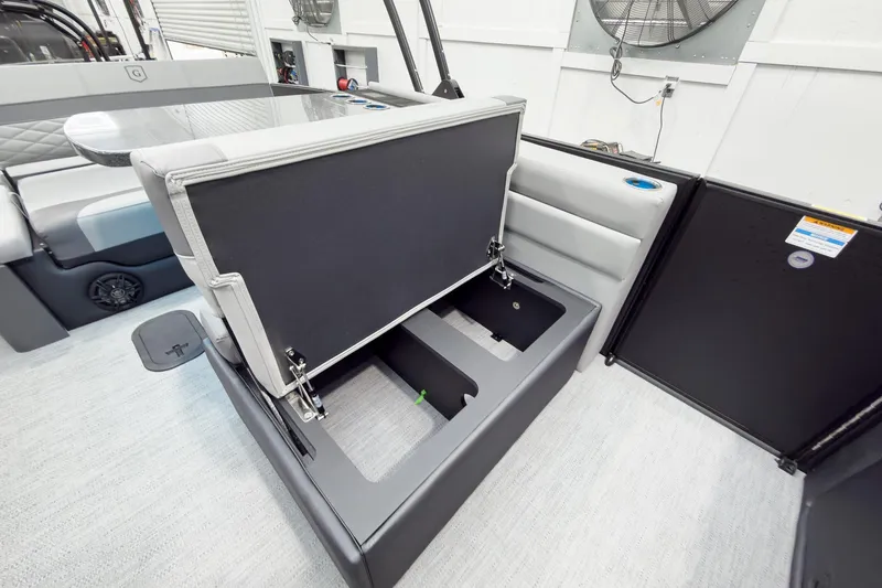 Slide: The Image of 2026 Godfrey Monaco 25' Tritoon with mid-table flip lounge storage compartment open. - 33